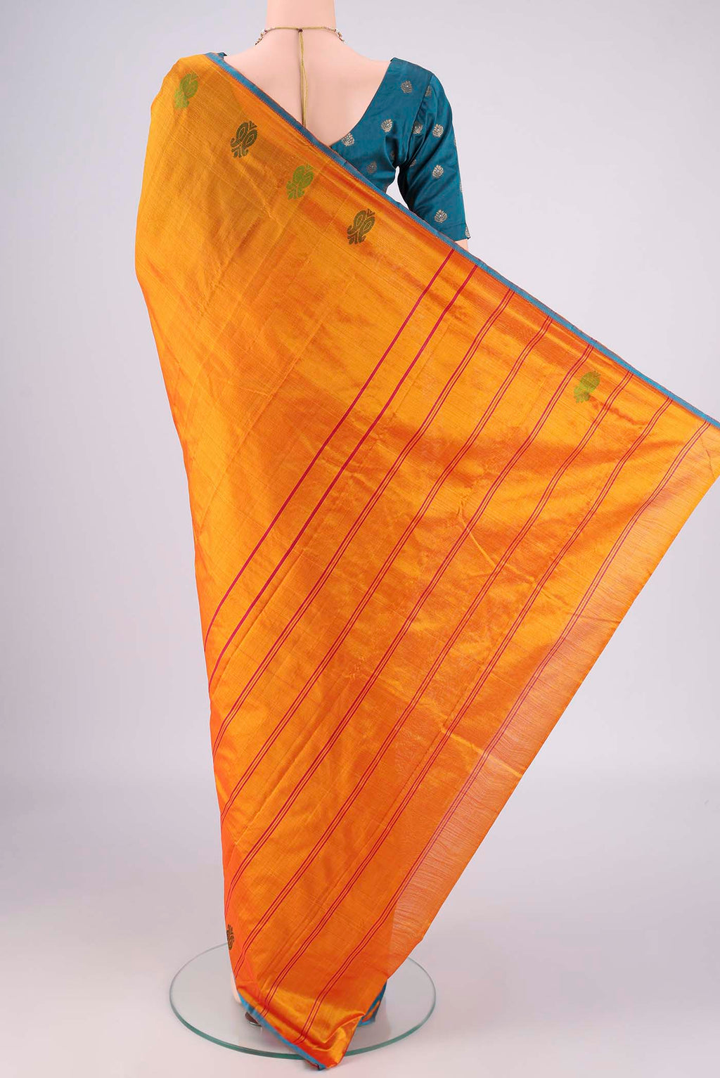 Flat view of Orange Kanchipuram Silk Saree with Plain Body and Thread Border. 