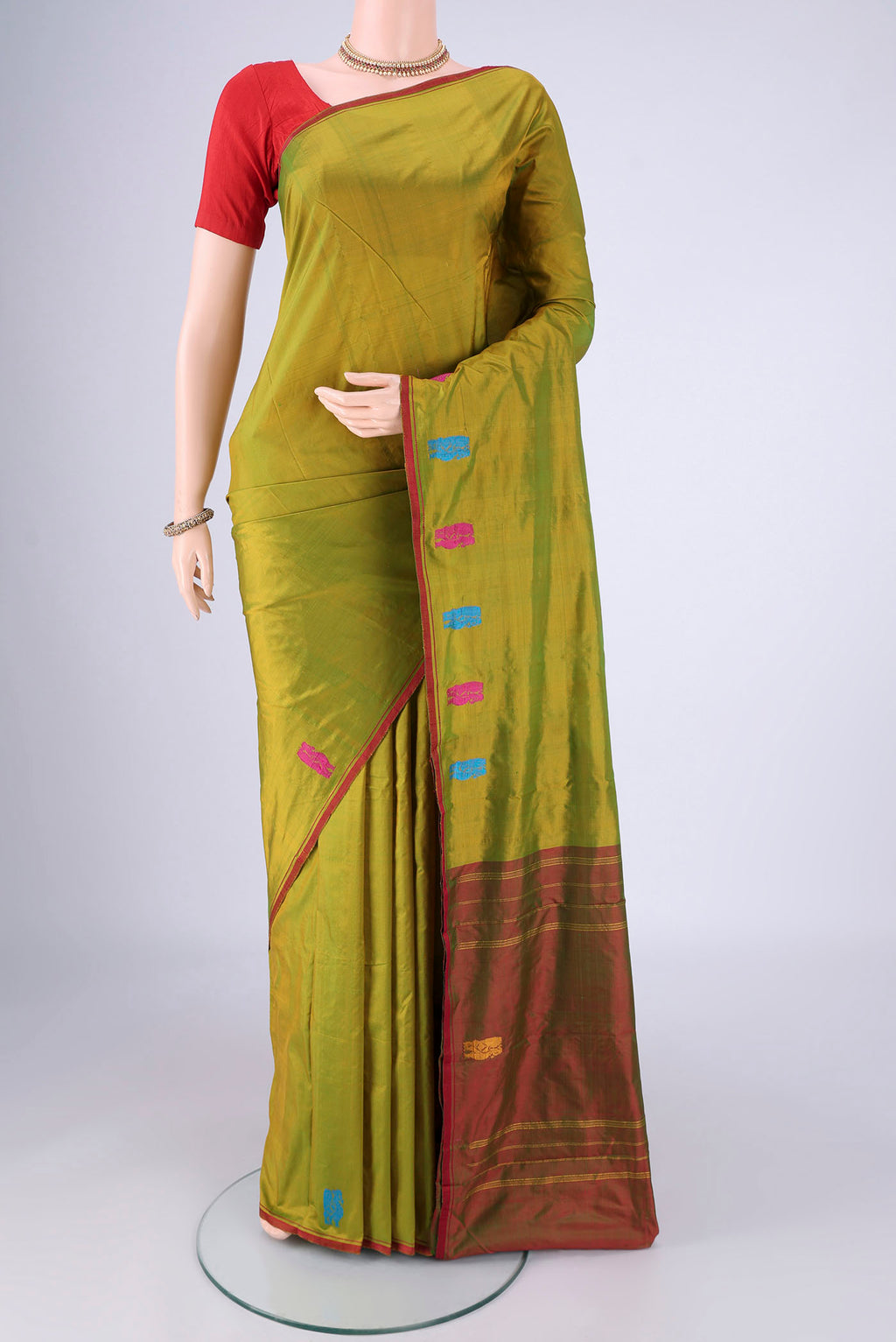 Mehandi Green Dual Tone Kanchipuram Silk Saree with Plain Body and Thread Border.  displayed on a mannequin