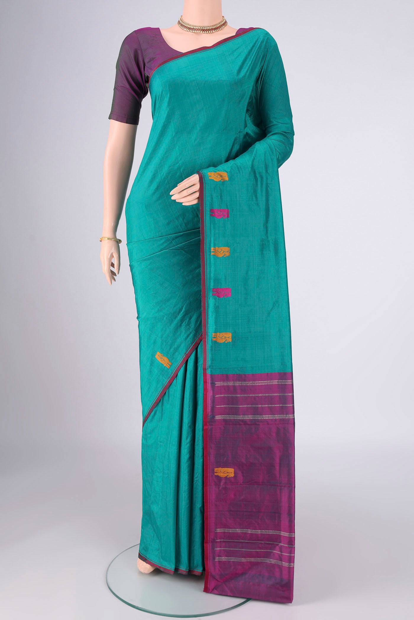 Turquoise Kanchipuram Silk Saree with Plain Body and Thread Border.  displayed on a mannequin