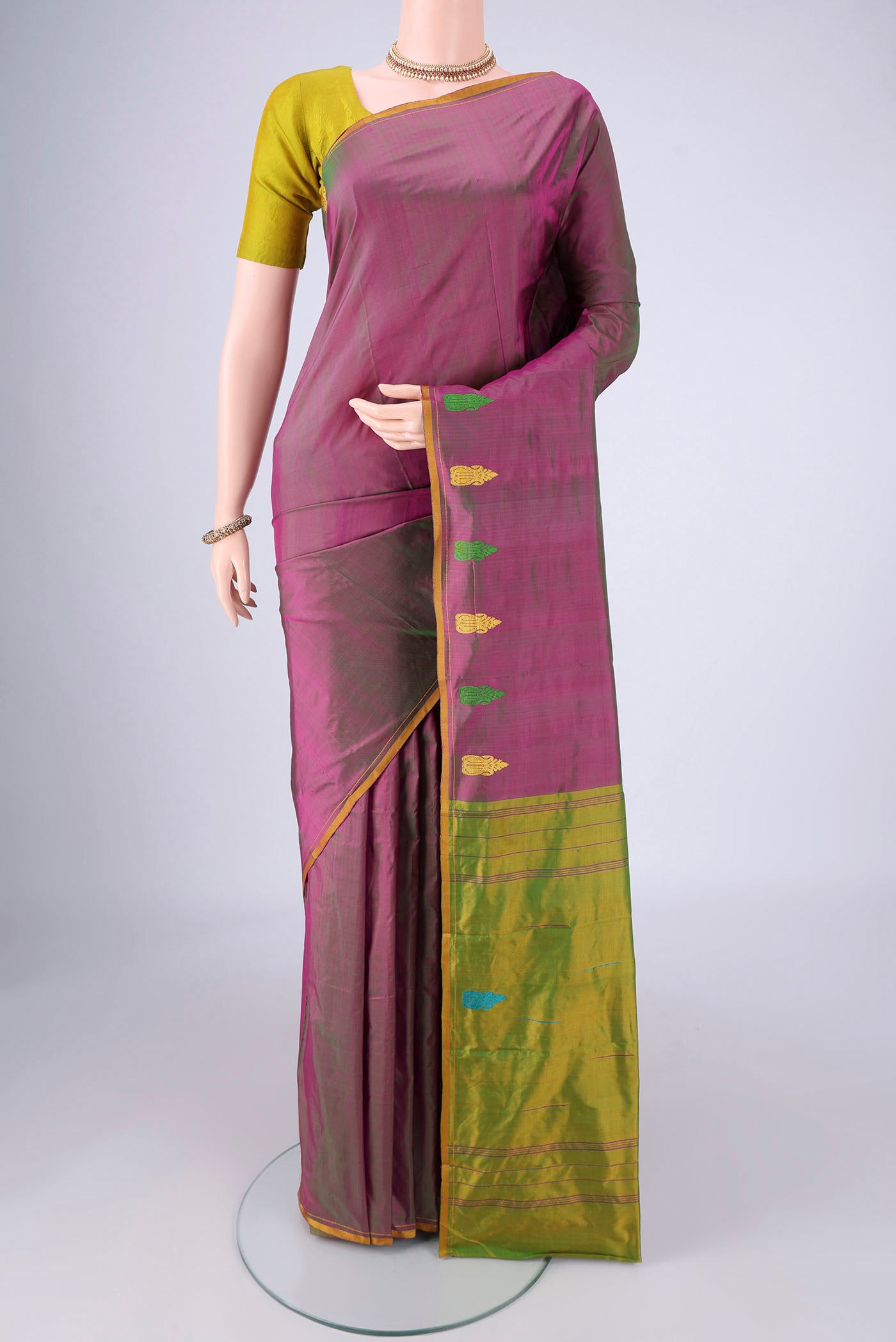 Purple Kanchipuram Silk Saree with Plain Body and Thread Border.  displayed on a mannequin