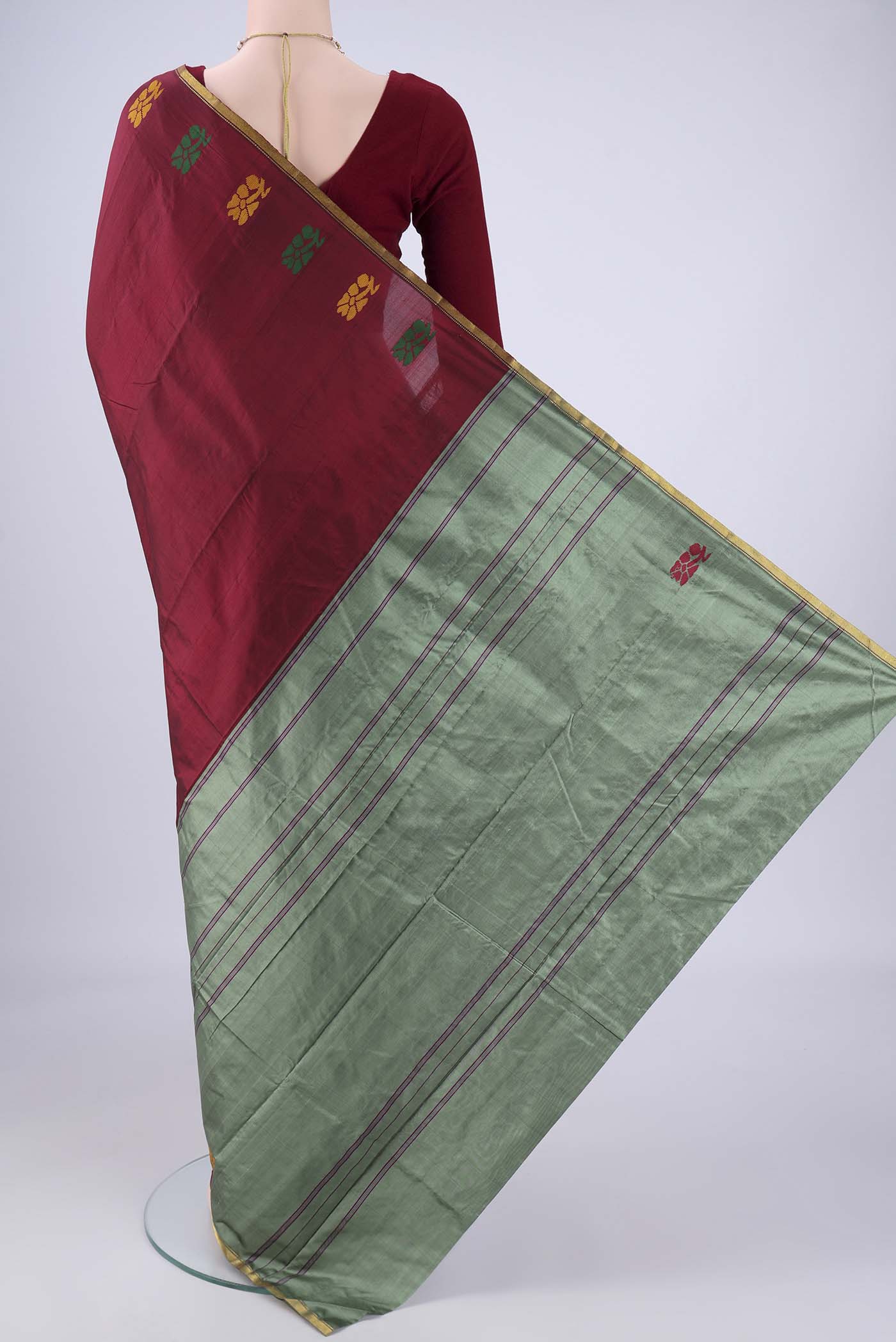 Flat view of Maroon Kanchipuram Silk Saree with Plain Body and Zari Border. 