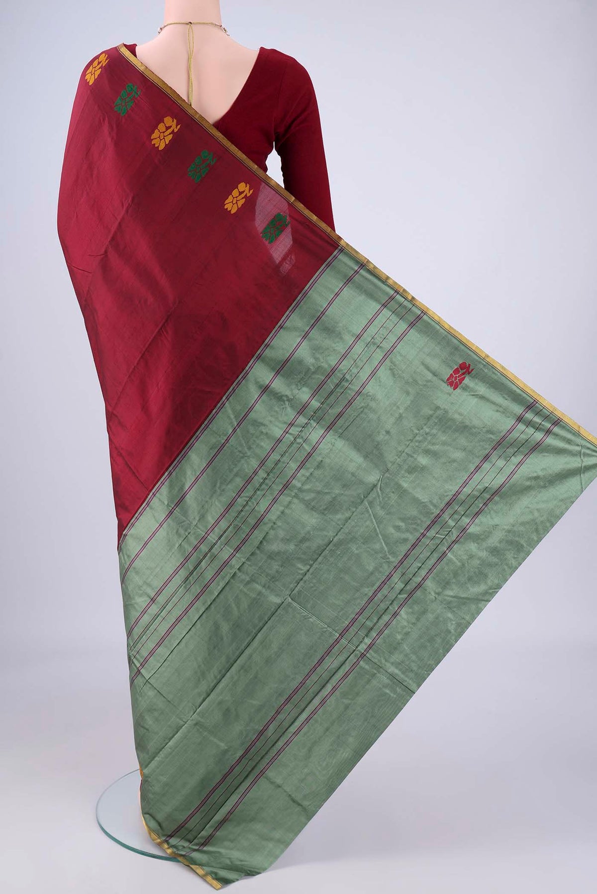 Flat view of Maroon Kanchipuram Silk Saree with Plain Body and Zari Border. 