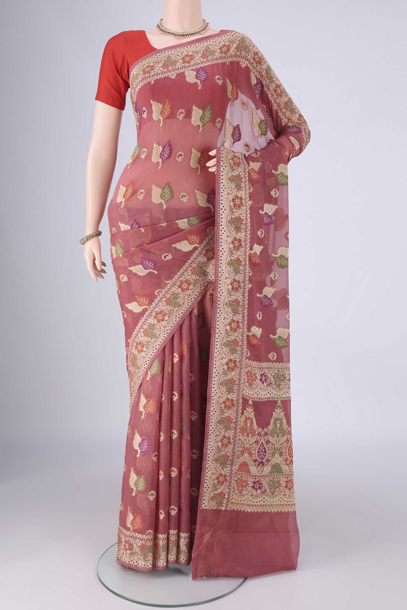 Rose Gold Blended Banarasi Georgette Saree with Zari And Thread Butta on the body and Zari And Thread Border.  displayed on a mannequin