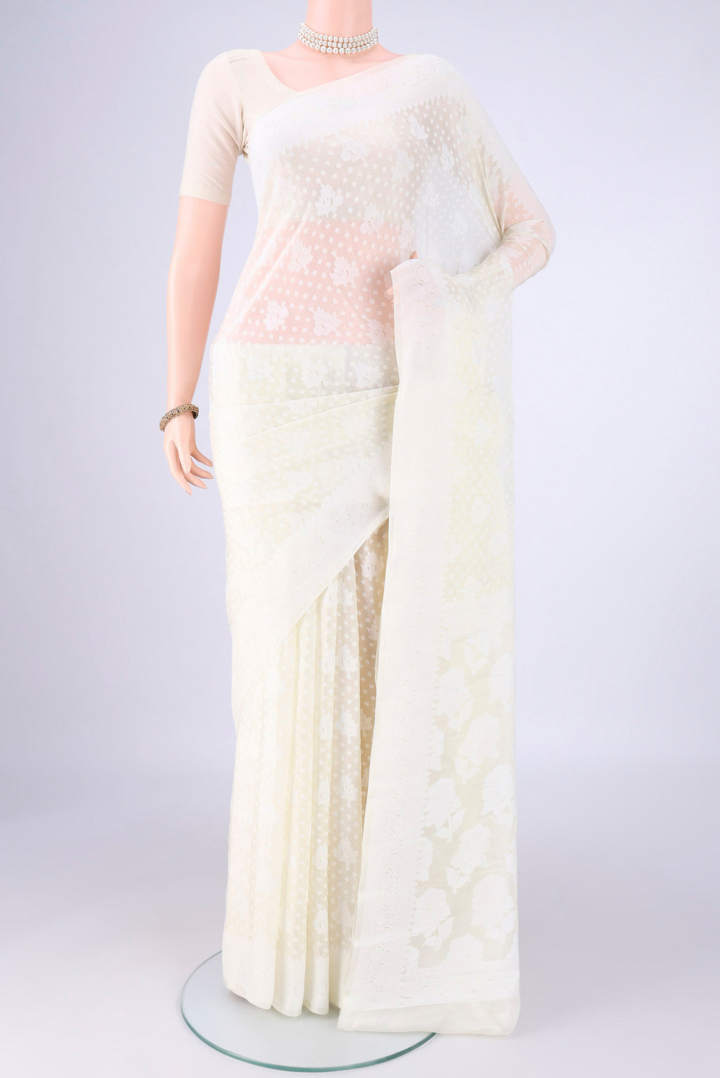 Off White Blended Banarasi Georgette Saree with Thread Butta on the body and Thread Border.  displayed on a mannequin