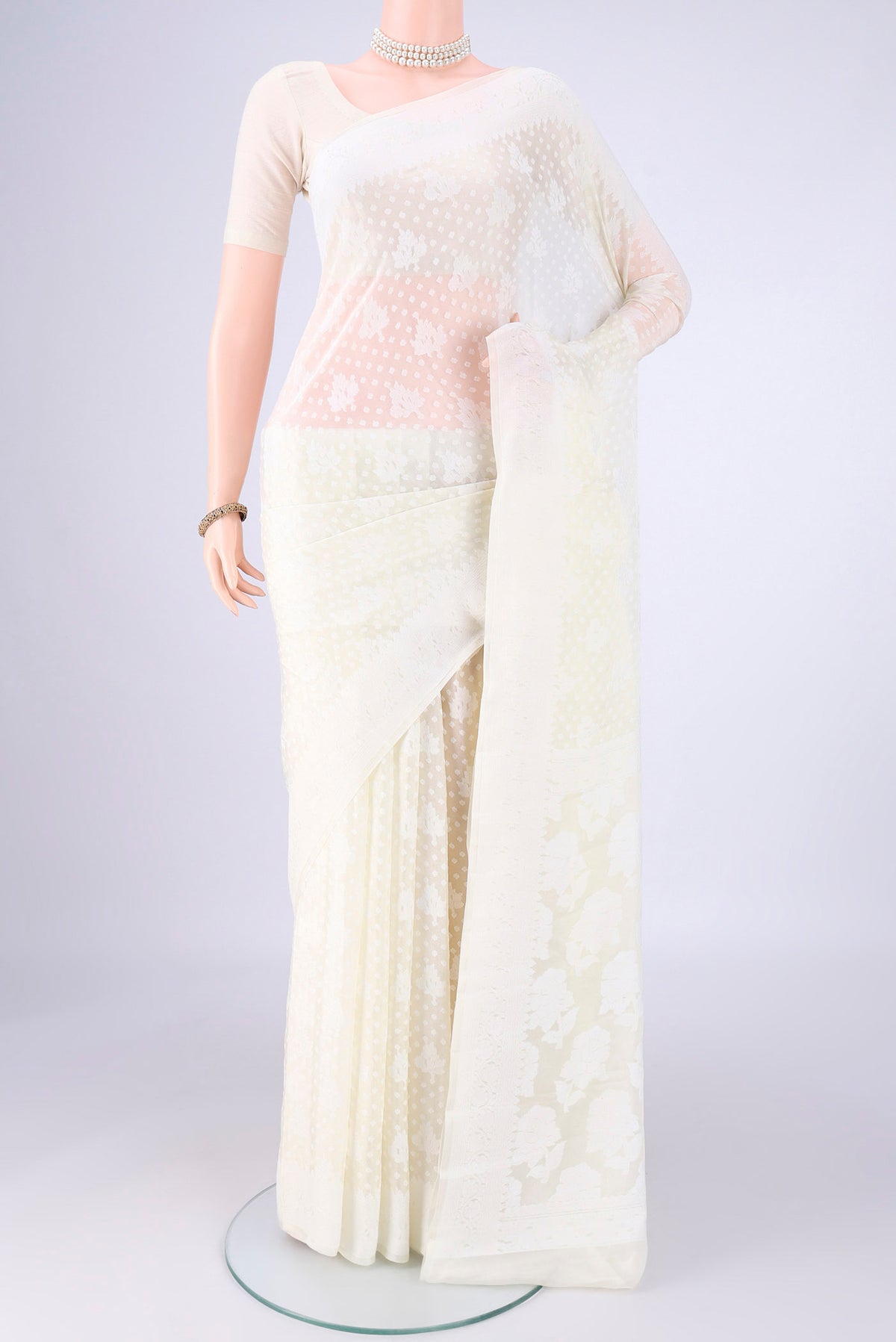 Off White Blended Banarasi Georgette Saree with Thread Butta on the body and Thread Border.  displayed on a mannequin