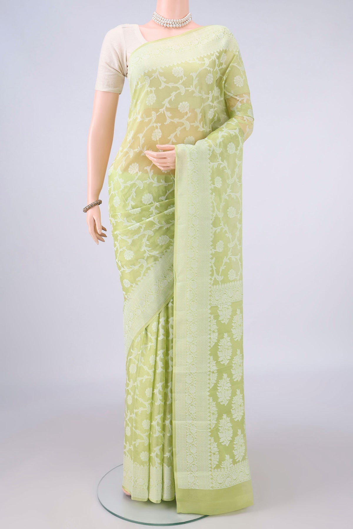 Light Green Blended Banarasi Georgette Saree with Thread Brocade on the body and Thread Border.  displayed on a mannequin