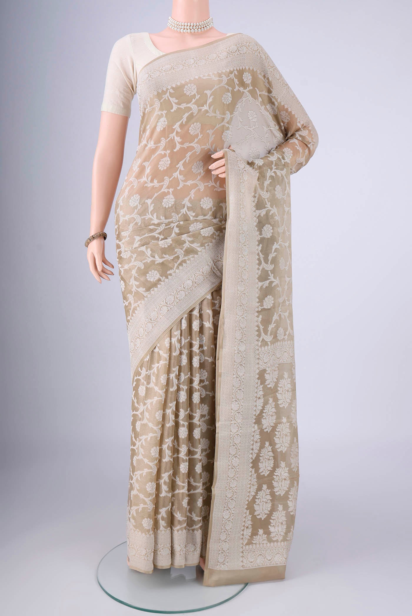 Dark Beige Blended Banarasi Georgette Saree with Thread Butta on the body and Thread Border.  displayed on a mannequin