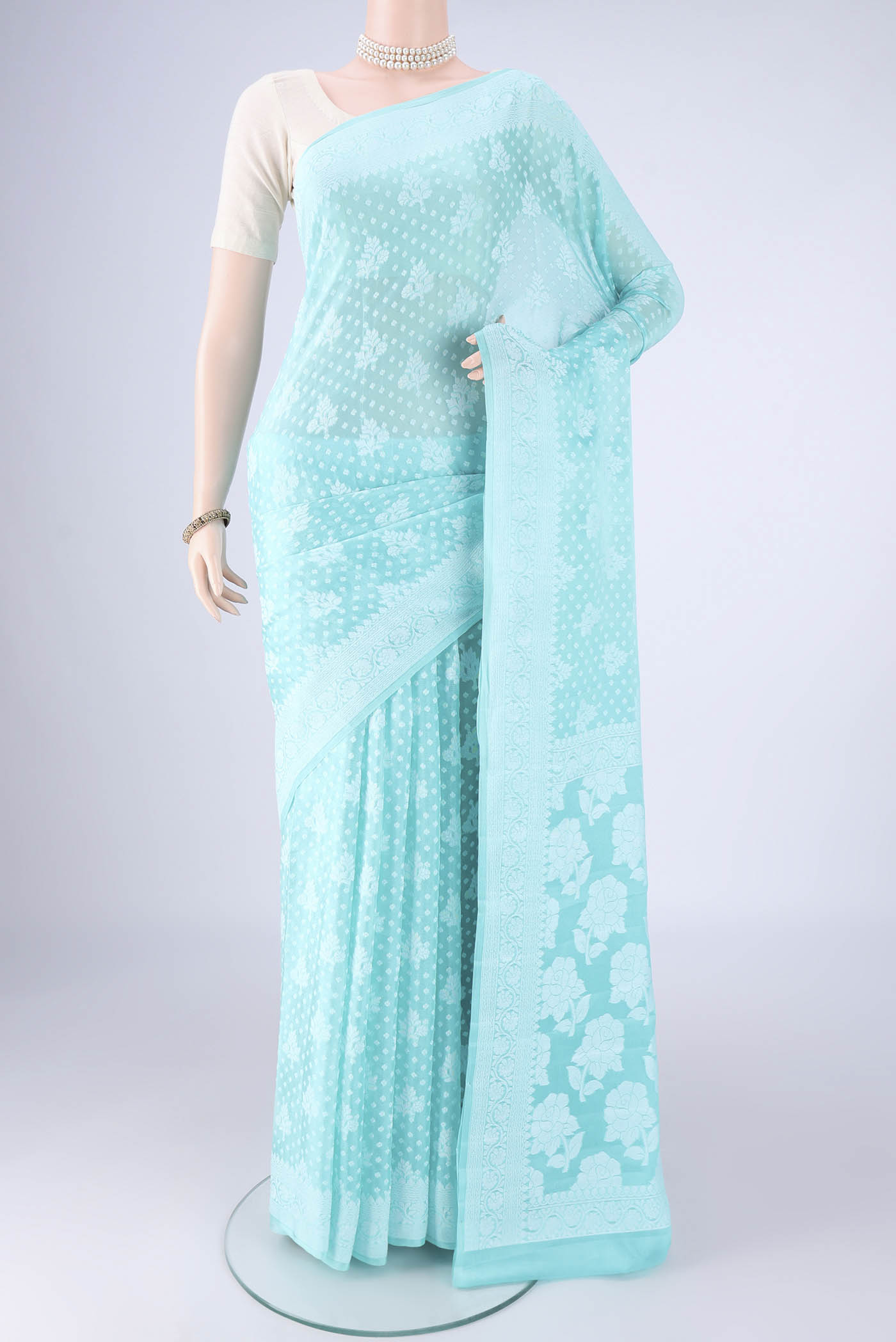 Turquoise Blended Banarasi Georgette Saree with Thread Butta on the body and Thread Border.  displayed on a mannequin