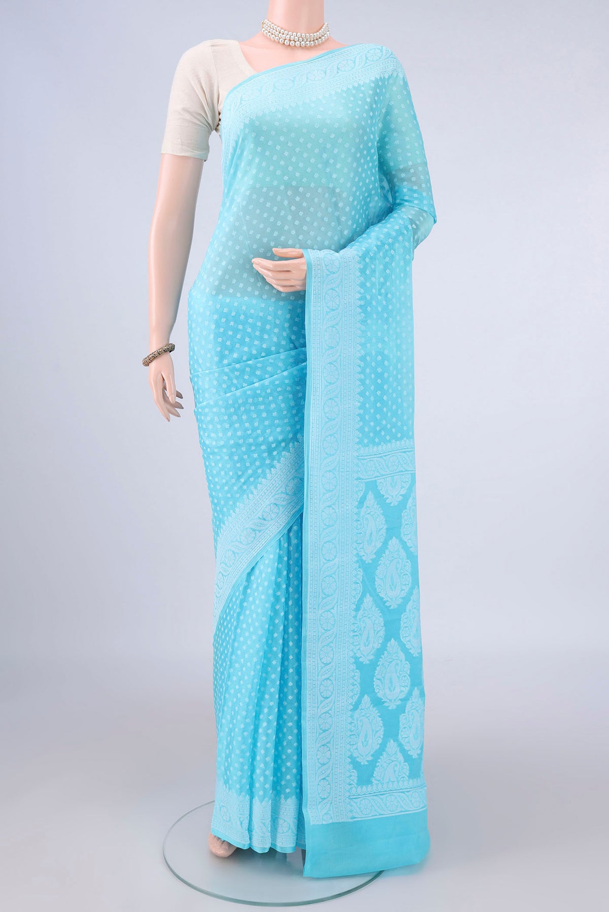Sky Blue Blended Banarasi Georgette Saree with Thread Butta on the body and Thread Border.  displayed on a mannequin
