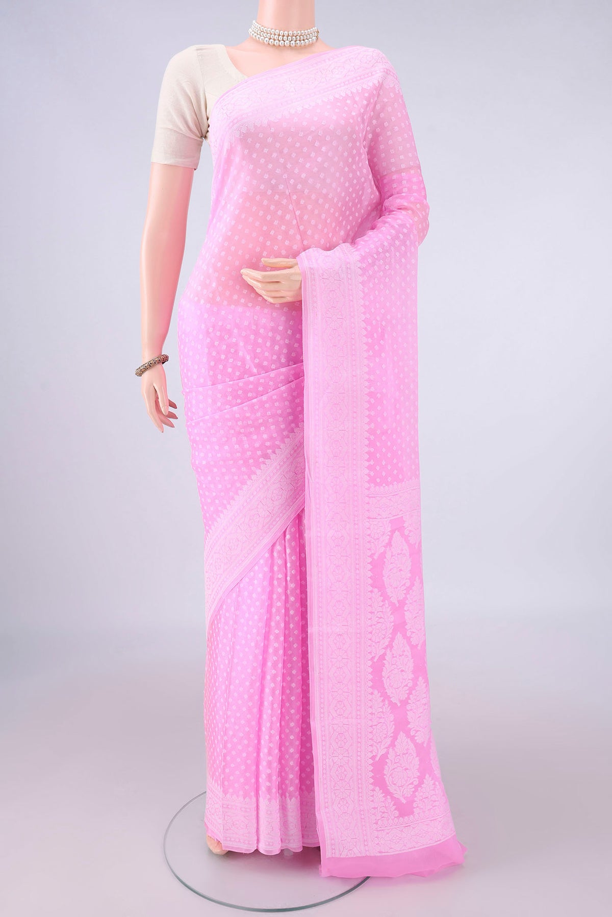 Rose pink Blended Banarasi Georgette Saree with Thread Brocade on the body and Thread Border.  displayed on a mannequin