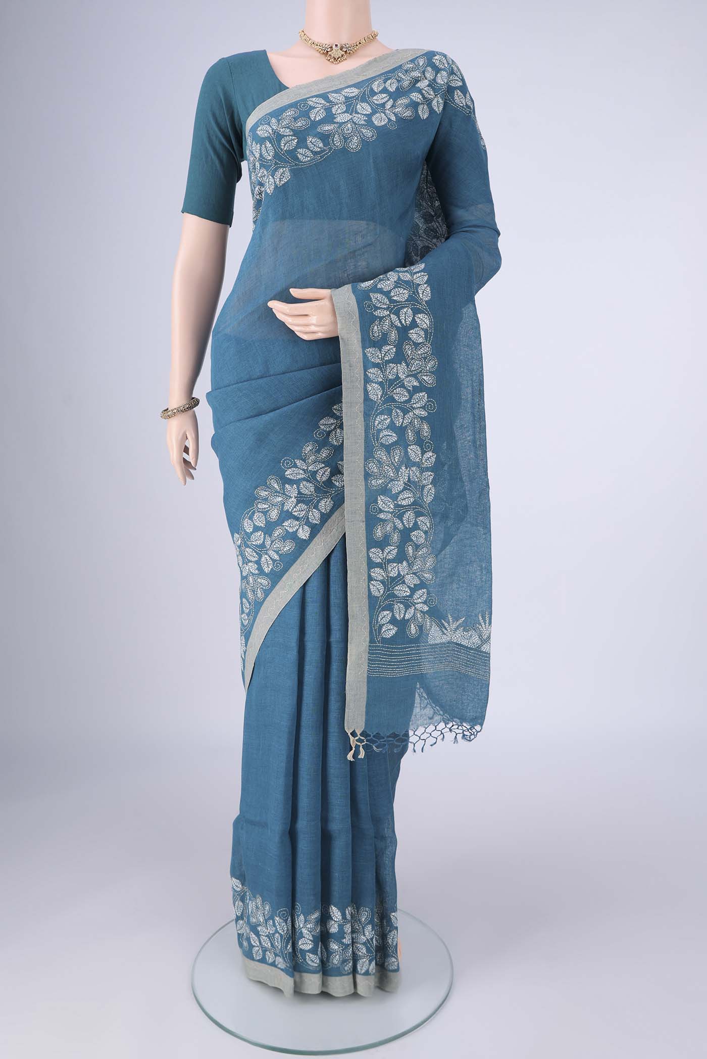 Blue Linen Cotton Saree with Kantha Work on the body and Thread Border.  displayed on a mannequin