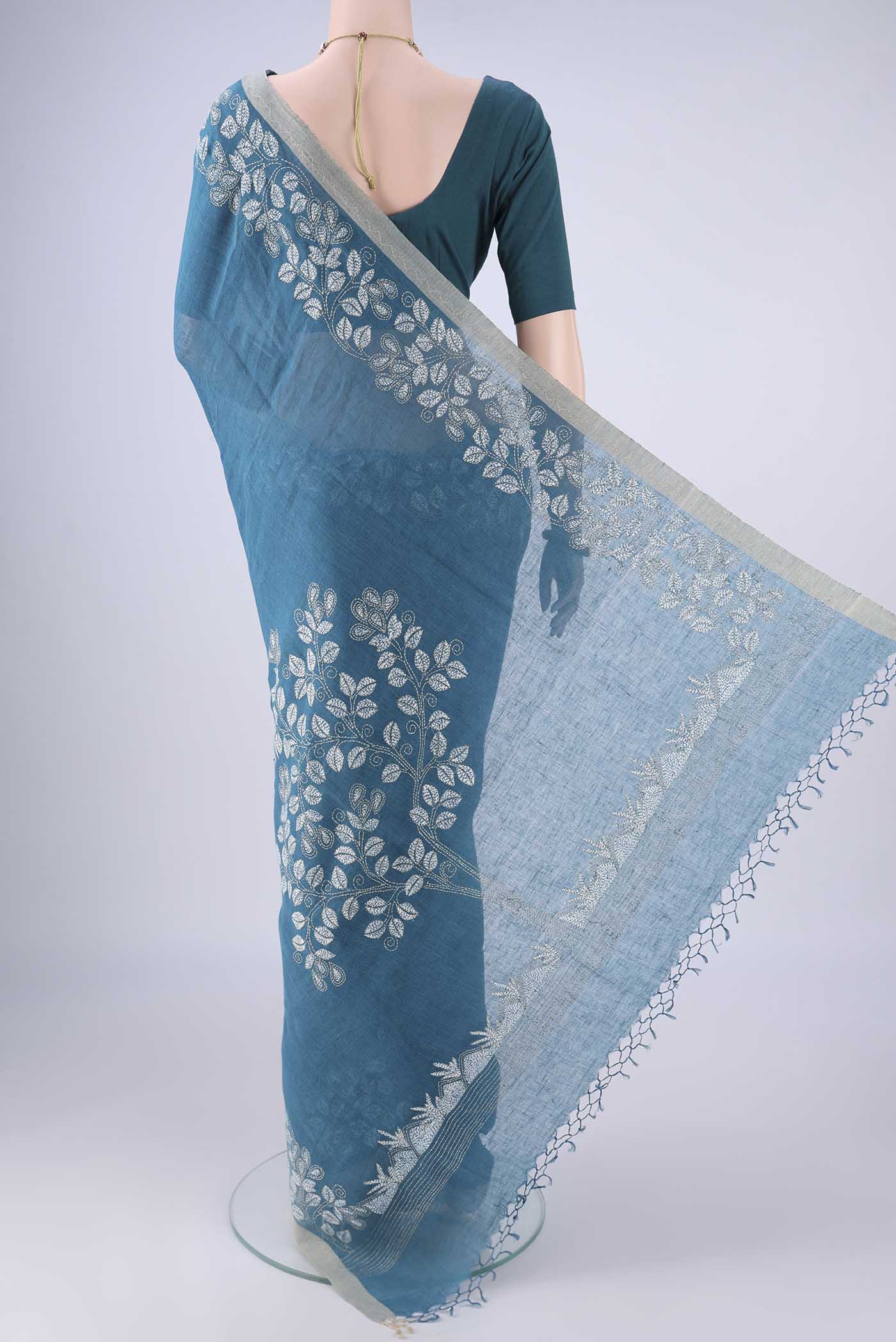 Flat view of Blue Linen Cotton Saree with Kantha Work on the body and Thread Border. 