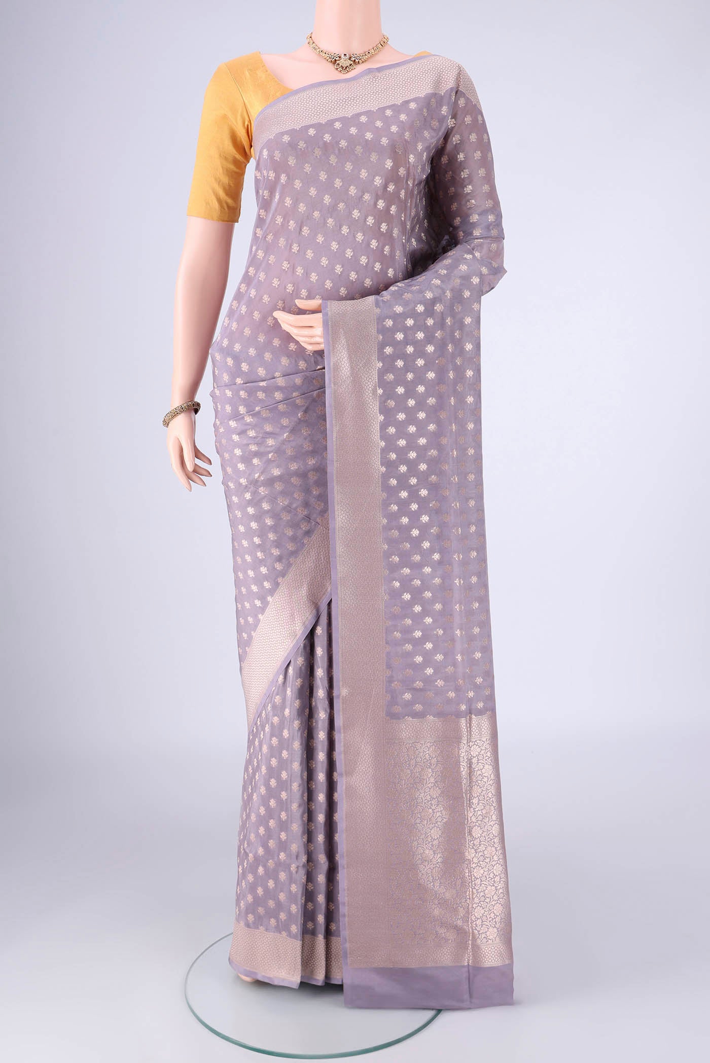 Mauve Banarasi Silk Saree with Zari Butta on the body and Zari Border.  displayed on a mannequin