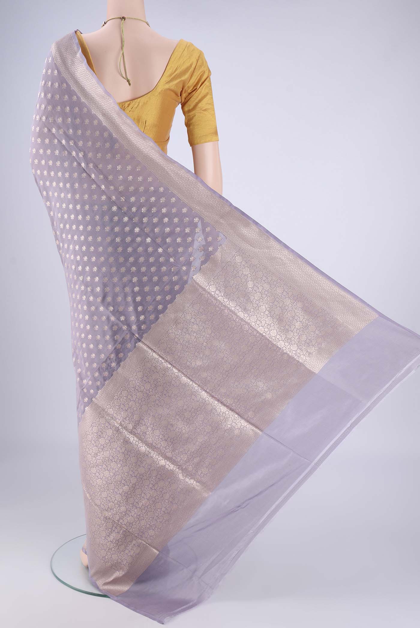 Flat view of Mauve Banarasi Silk Saree with Zari Butta on the body and Zari Border. 