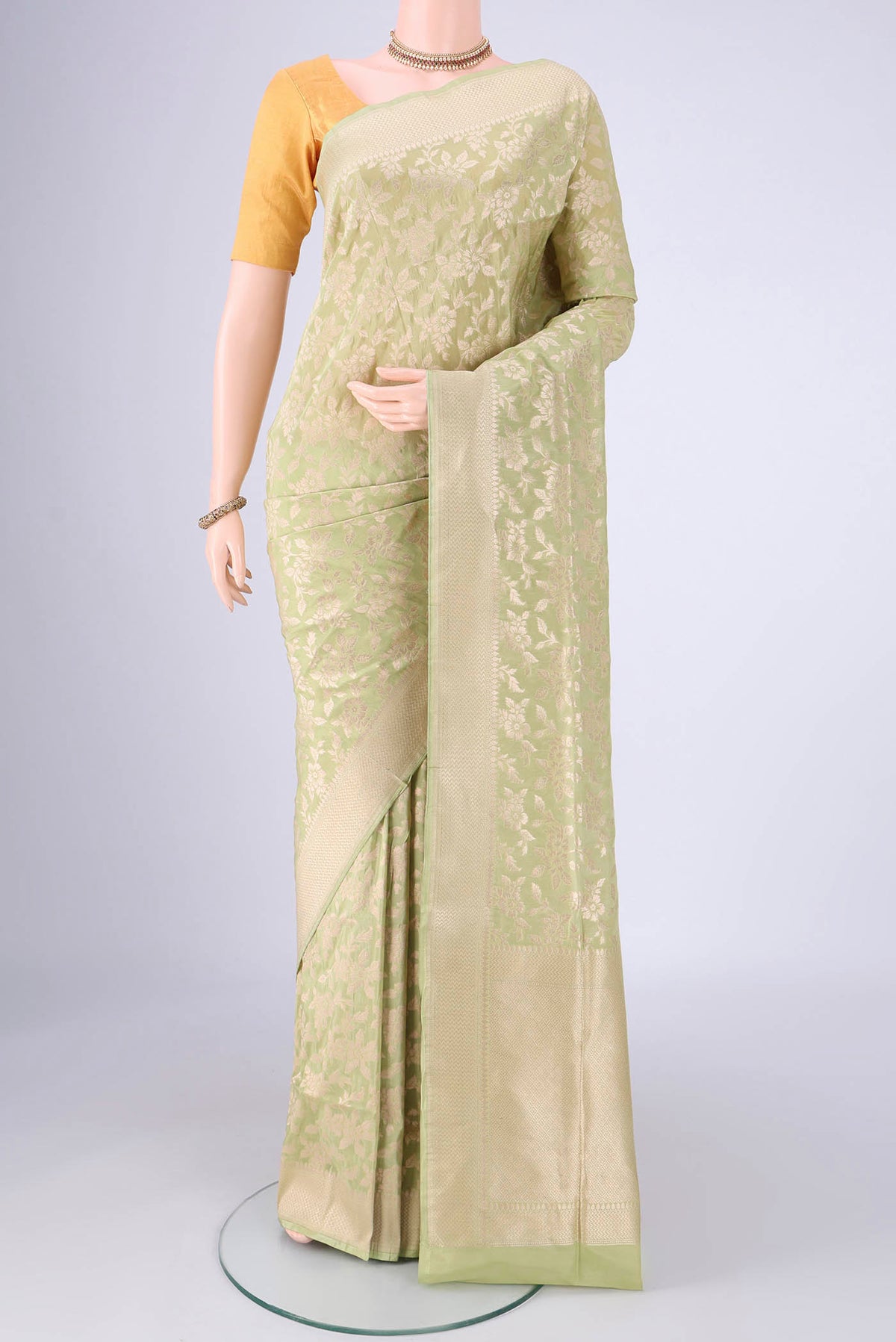 Light Green Banarasi Silk Saree with Zari Brocade on the body and Zari Border.  displayed on a mannequin