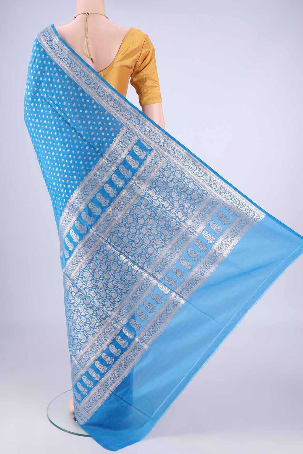 Flat view of Electric Blue Banarasi Silk Saree with Zari Butta on the body and Zari Border. 