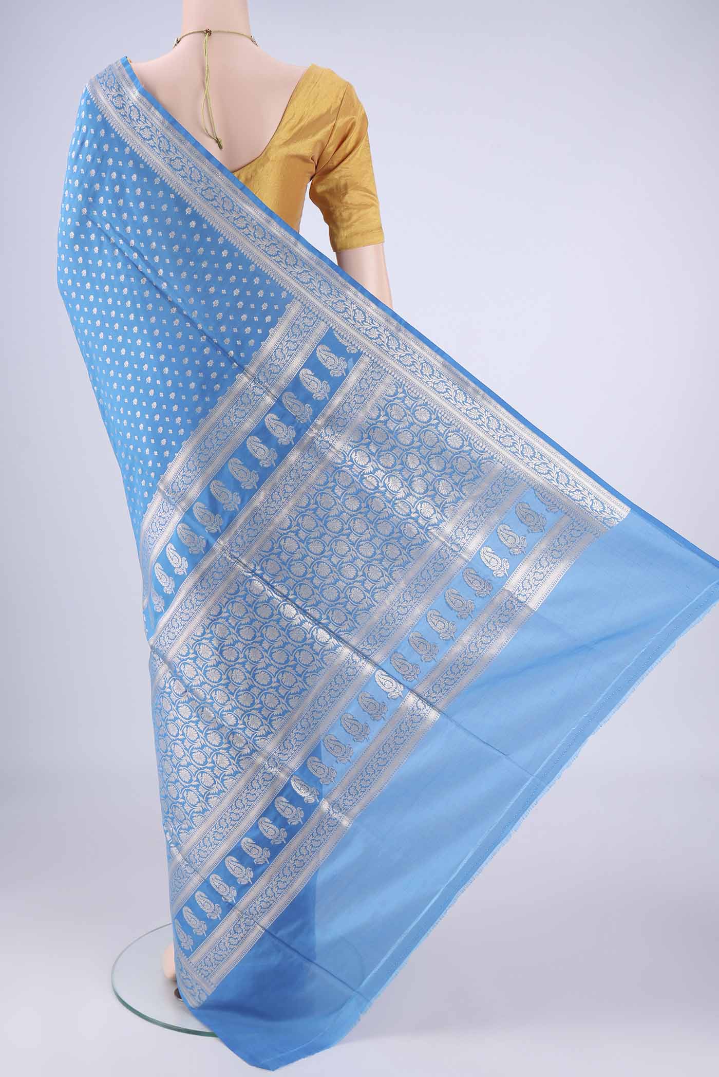 Flat view of Electric Blue Banarasi Silk Saree with Zari Butta on the body and Zari Border. 