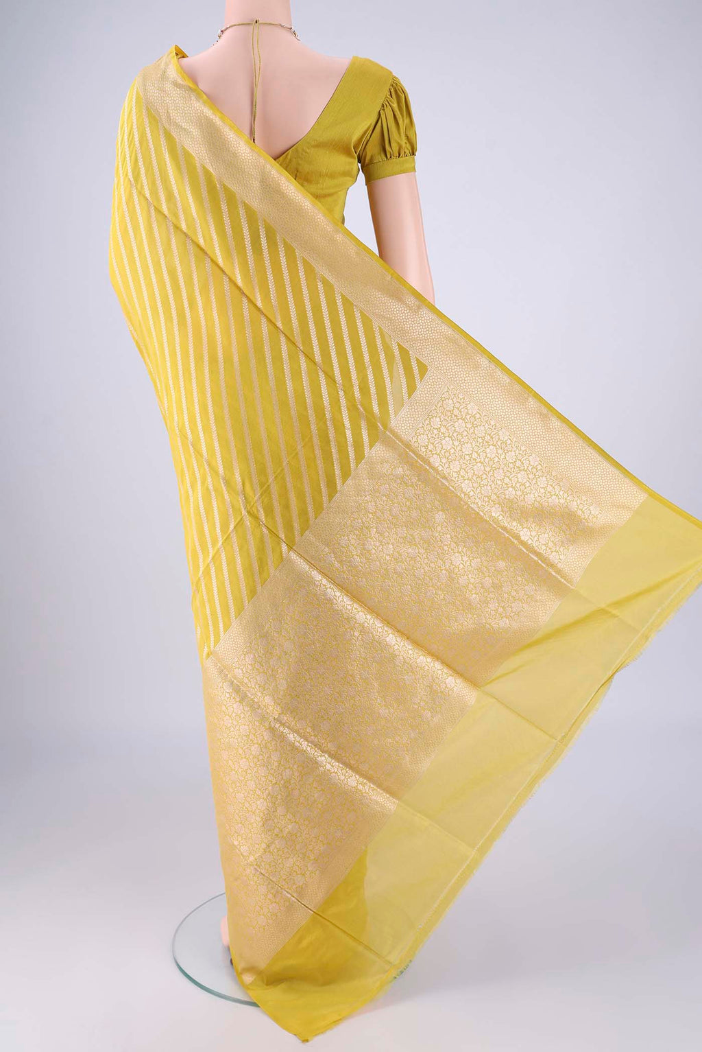 Flat view of Yellow Banarasi Silk Saree with Stripes on the body and Zari Border. 