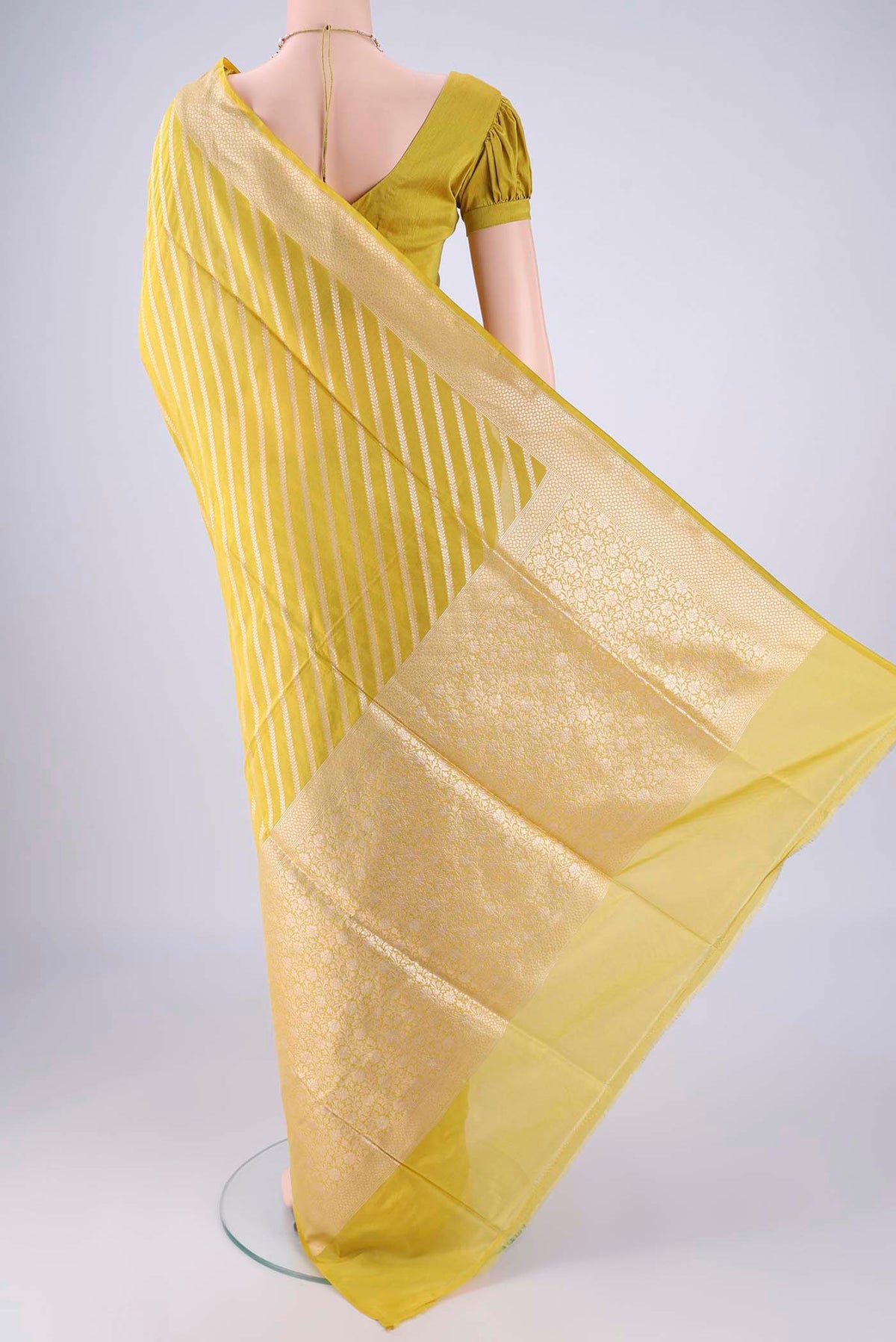Flat view of Yellow Banarasi Silk Saree with Stripes on the body and Zari Border. 