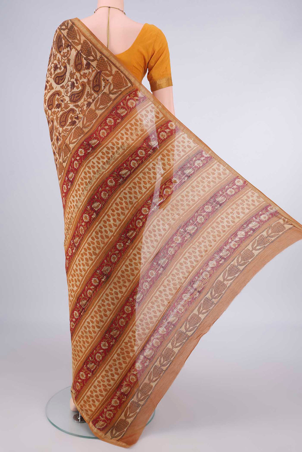 Flat view of Mustard Maheshwari Cotton Saree with Batik Print on the body and Zari Border. 