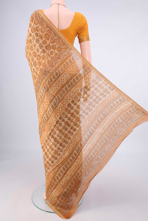 Flat view of Beige Chanderi Cotton Saree with Batik Print on the body and Zari Border. 