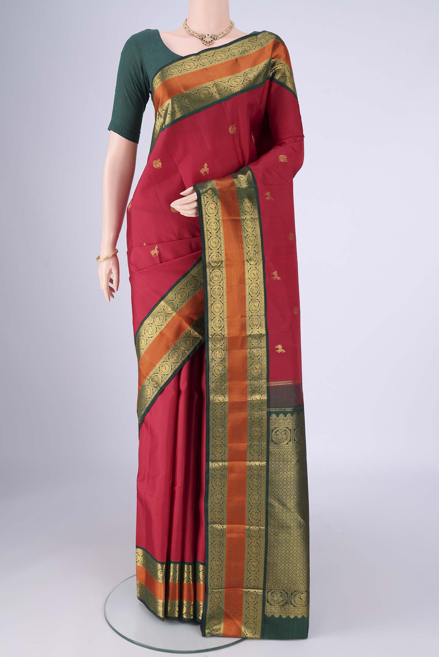 Maroon Kanjivaram Silk Saree with Zari Butta on the body and Zari And Thread Border.  displayed on a mannequin