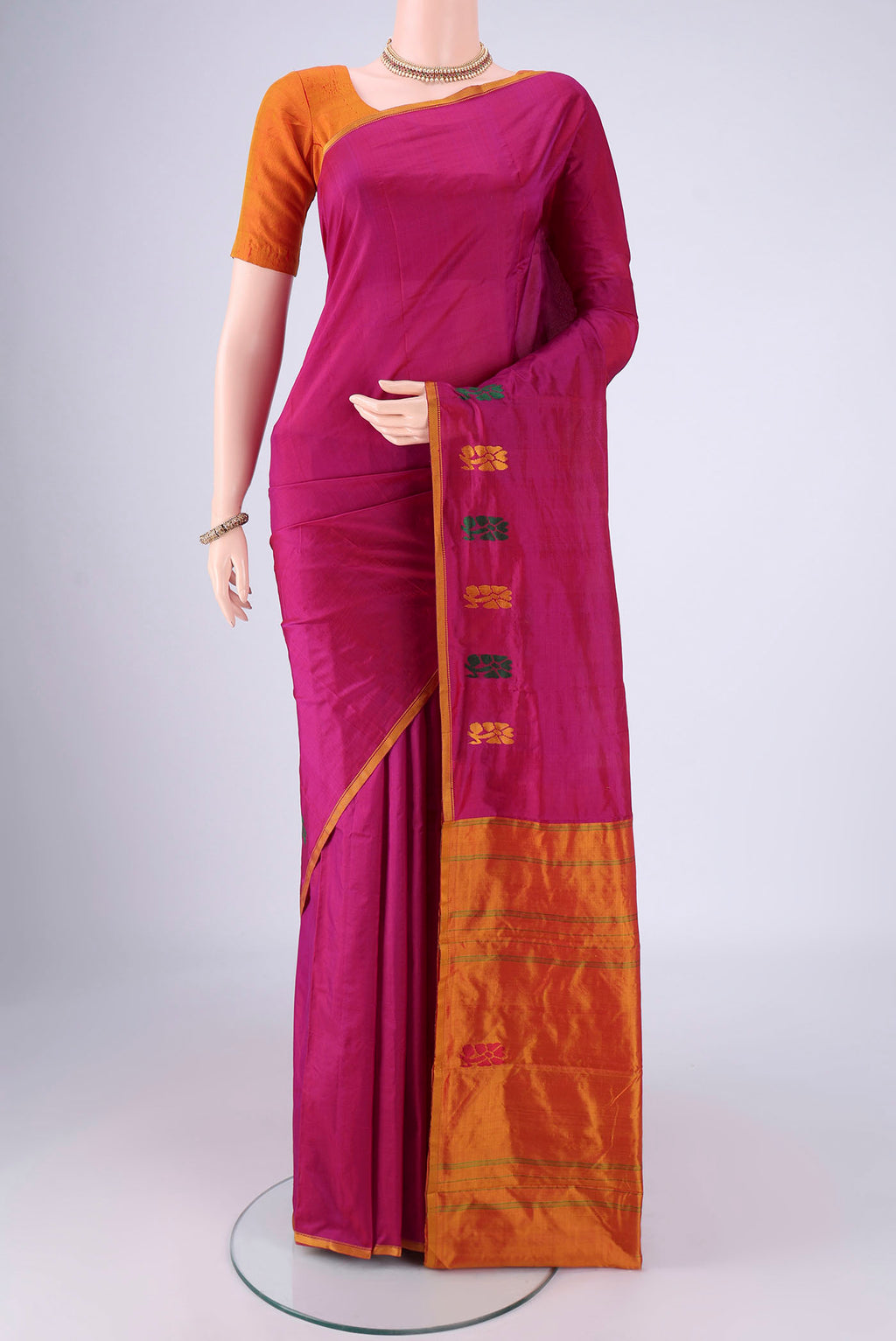 Magenta Kanchipuram Silk Saree with Plain Body and Thread Border.  displayed on a mannequin