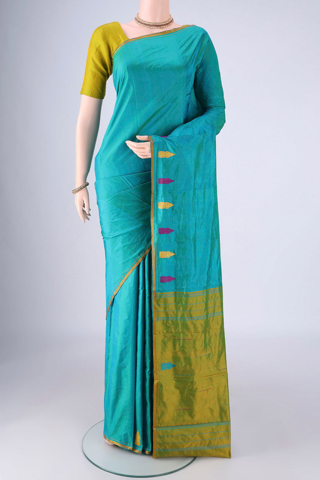 Turquoise Kanchipuram Silk Saree with Plain Body and Thread Border.  displayed on a mannequin