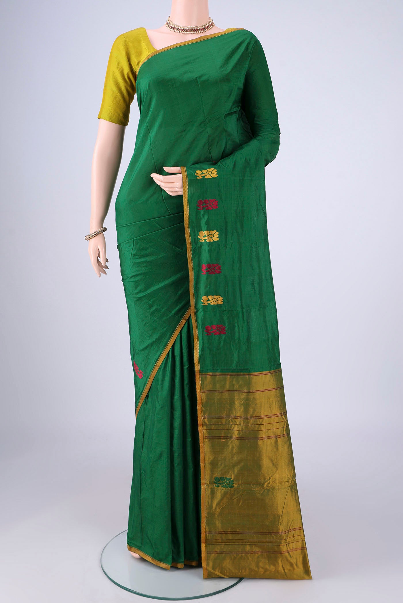 Bottle Green Kanchipuram Silk Saree with Plain Body and Thread Border.  displayed on a mannequin