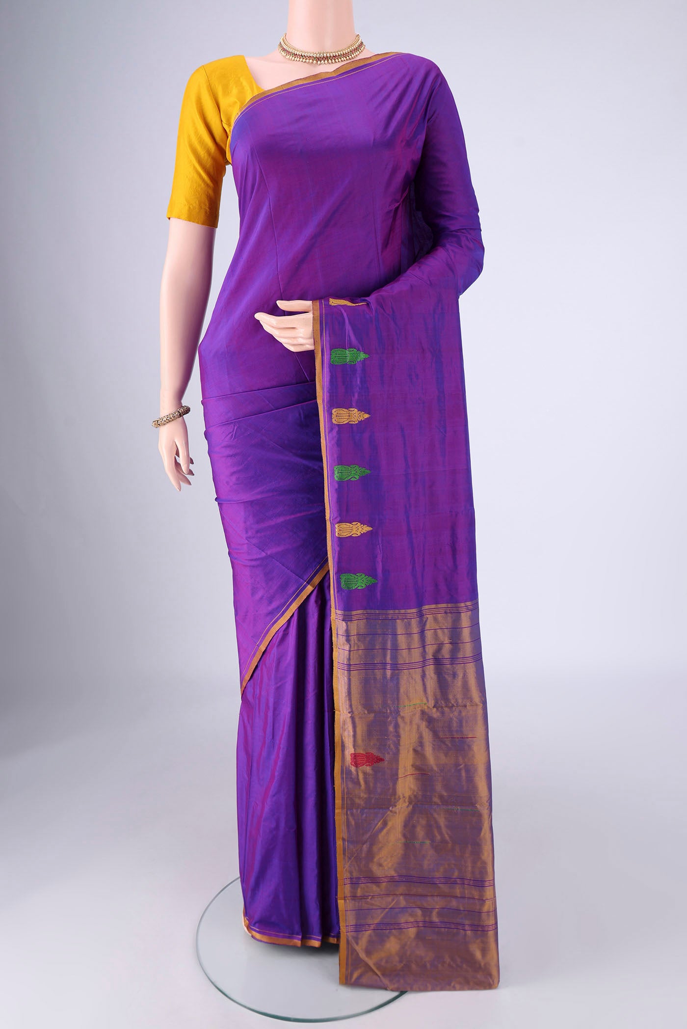 Purple Kanchipuram Silk Saree with Plain Body and Thread Border.  displayed on a mannequin