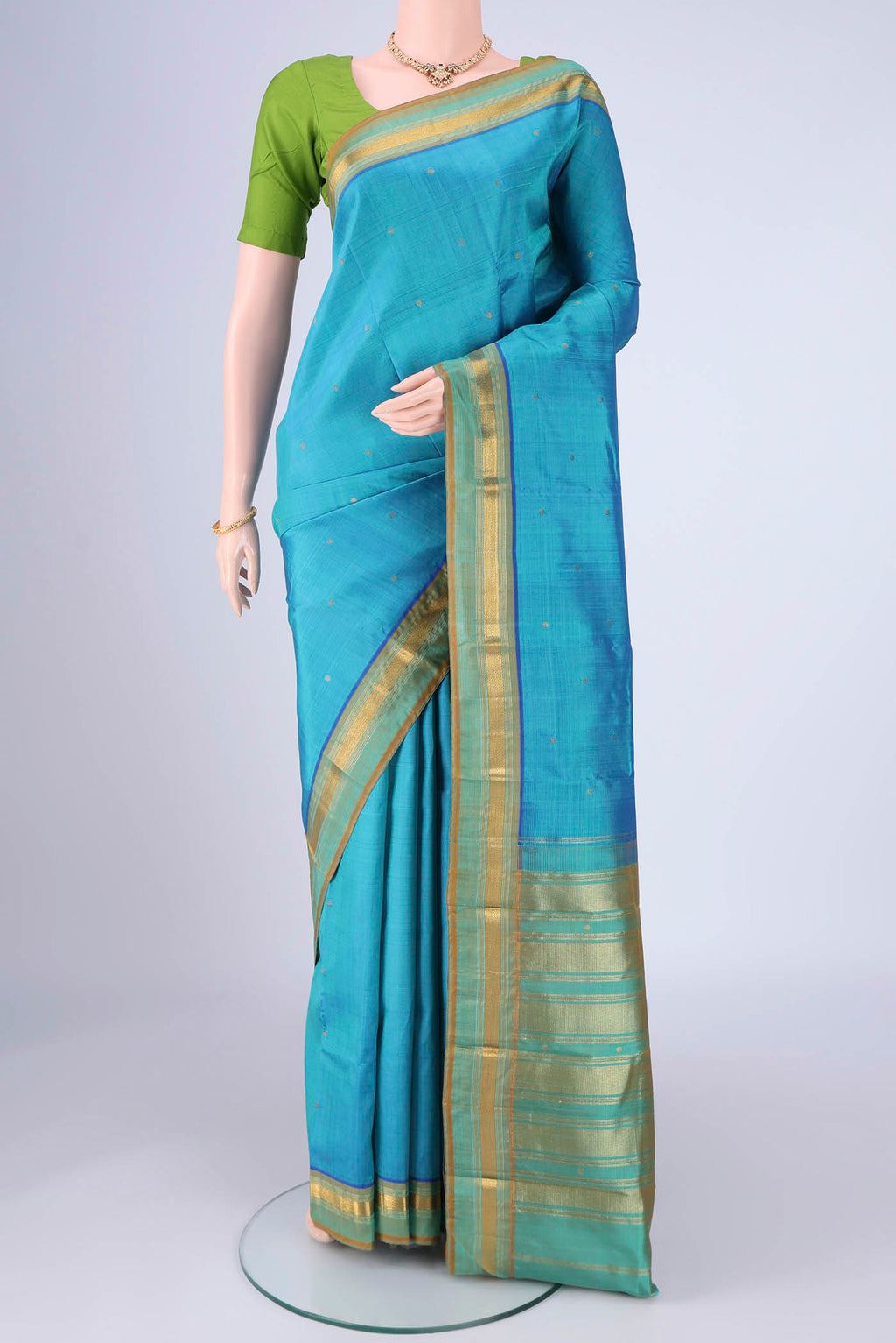 Sky Blue Kanchipuram Silk Saree with Zari Butta on the body and Zari Border.  displayed on a mannequin