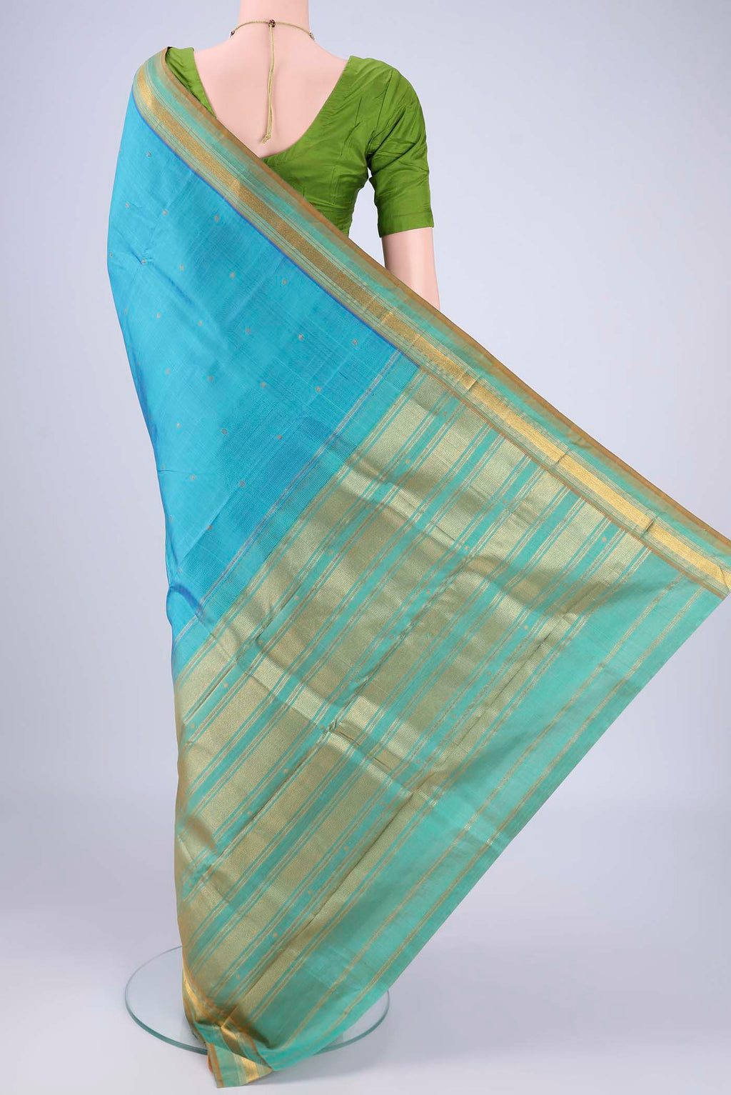 Flat view of Sky Blue Kanchipuram Silk Saree with Zari Butta on the body and Zari Border. 