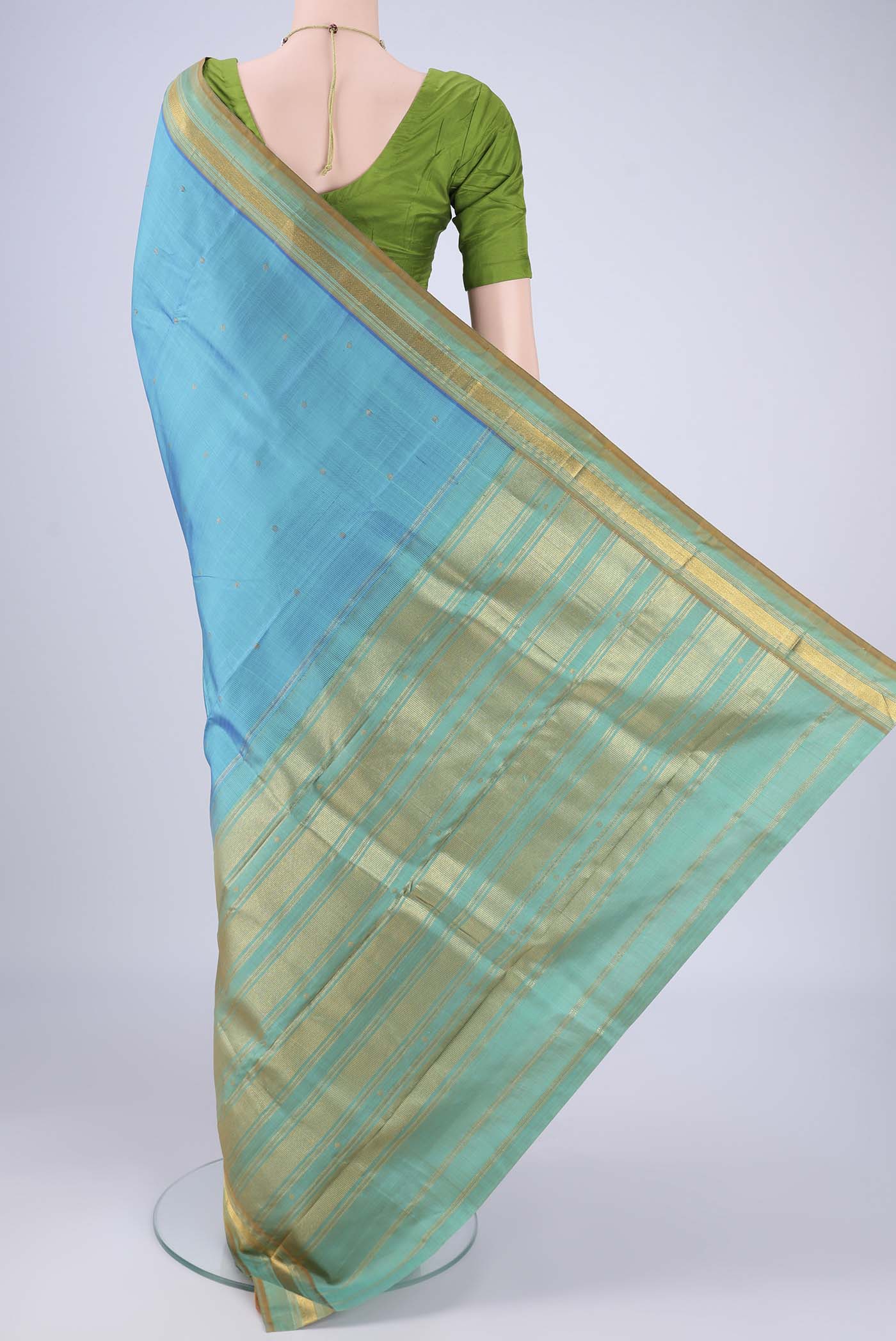 Flat view of Sky Blue Kanchipuram Silk Saree with Zari Butta on the body and Zari Border. 