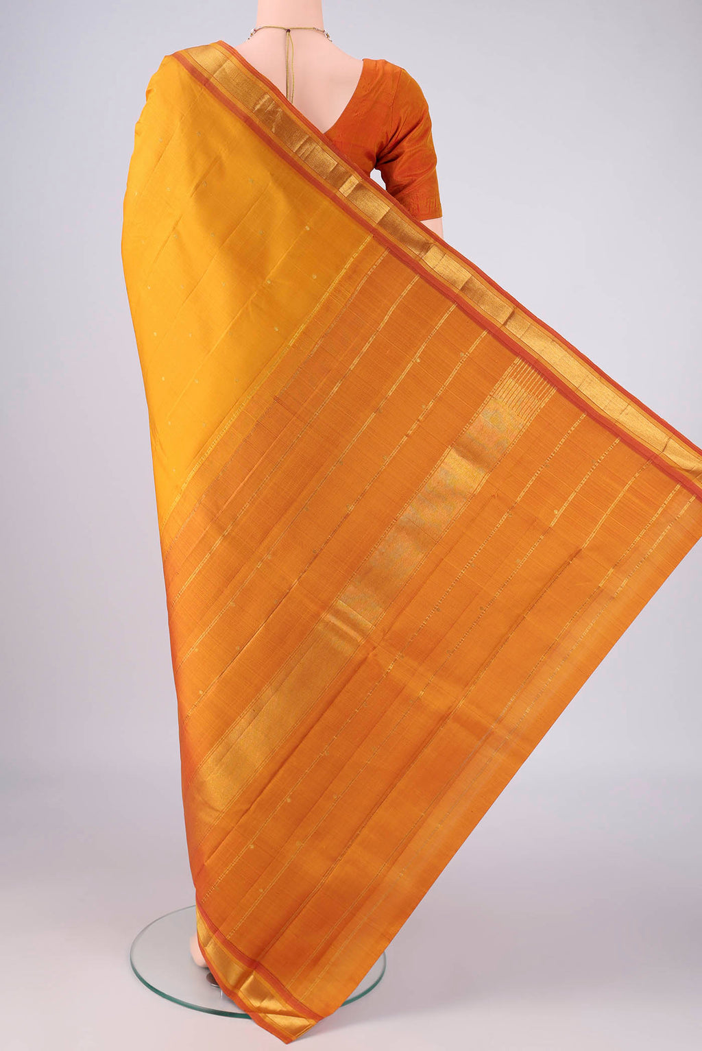 Flat view of Mustard Kanchipuram Silk Saree with Zari Butta on the body and Zari Border. 