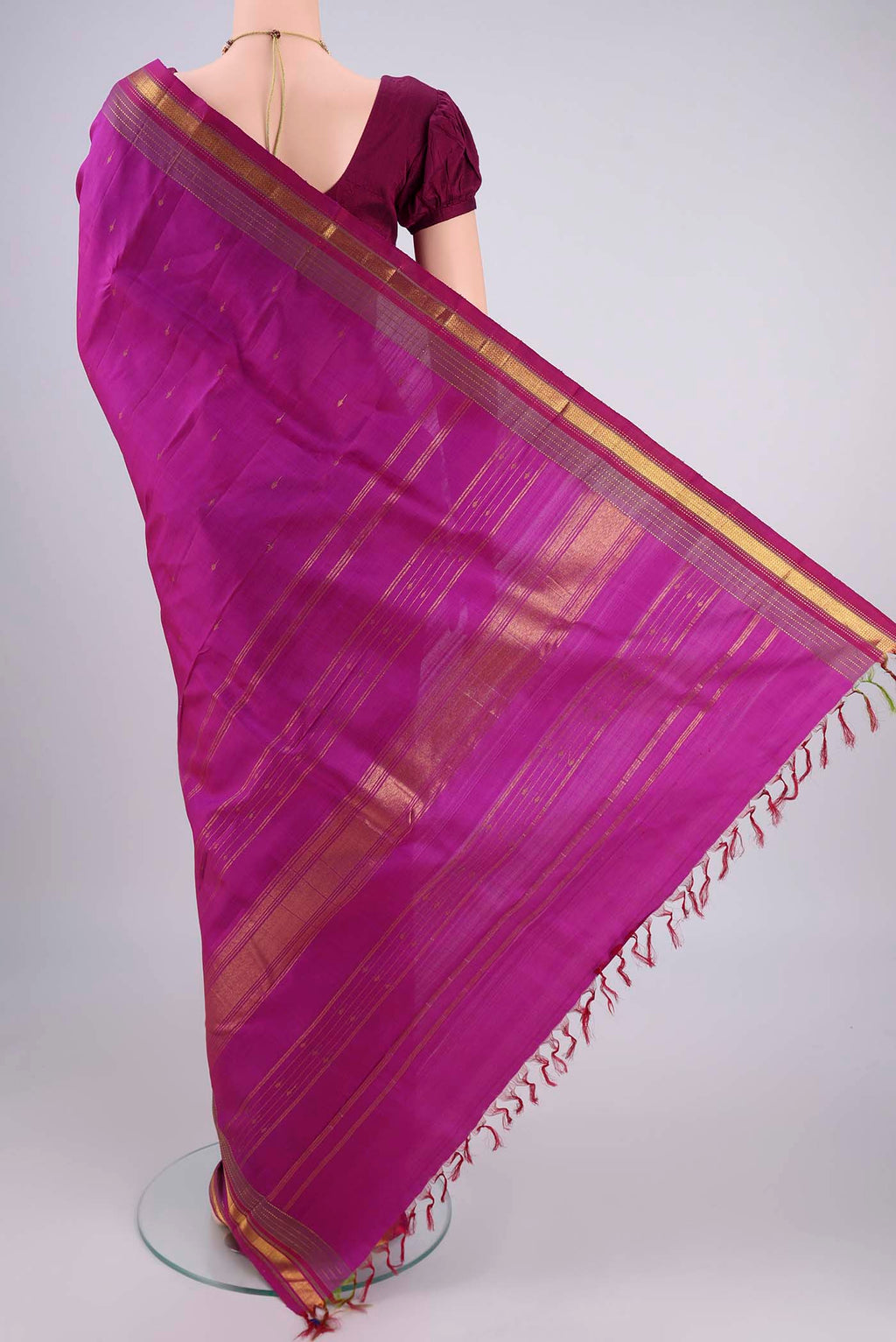 Flat view of Magenta Kanjivaram Silk Saree with Zari Butta on the body and Zari Border. 