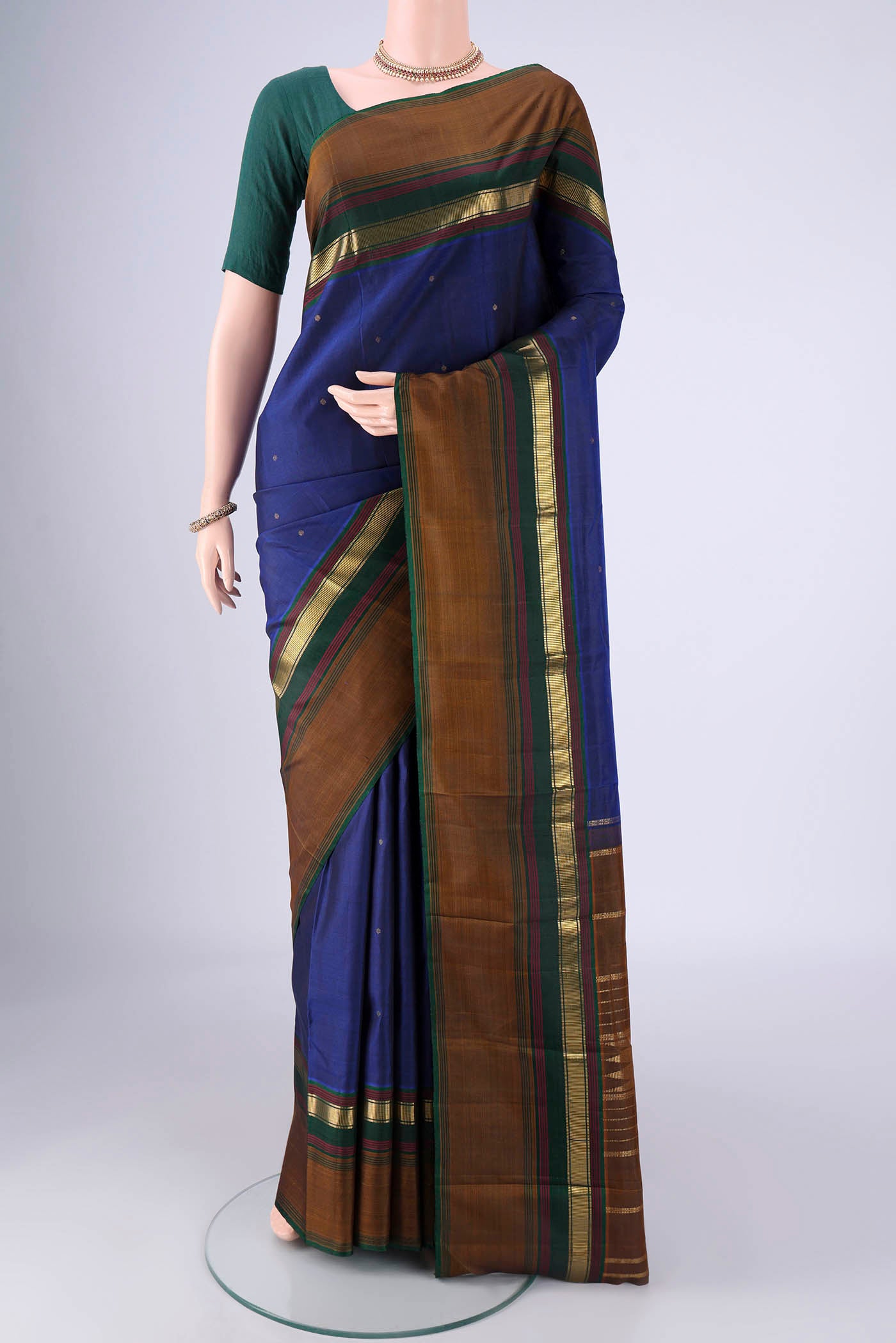 Dark Blue Kanchipuram Silk Saree with Zari Butta on the body and Zari Border.  displayed on a mannequin
