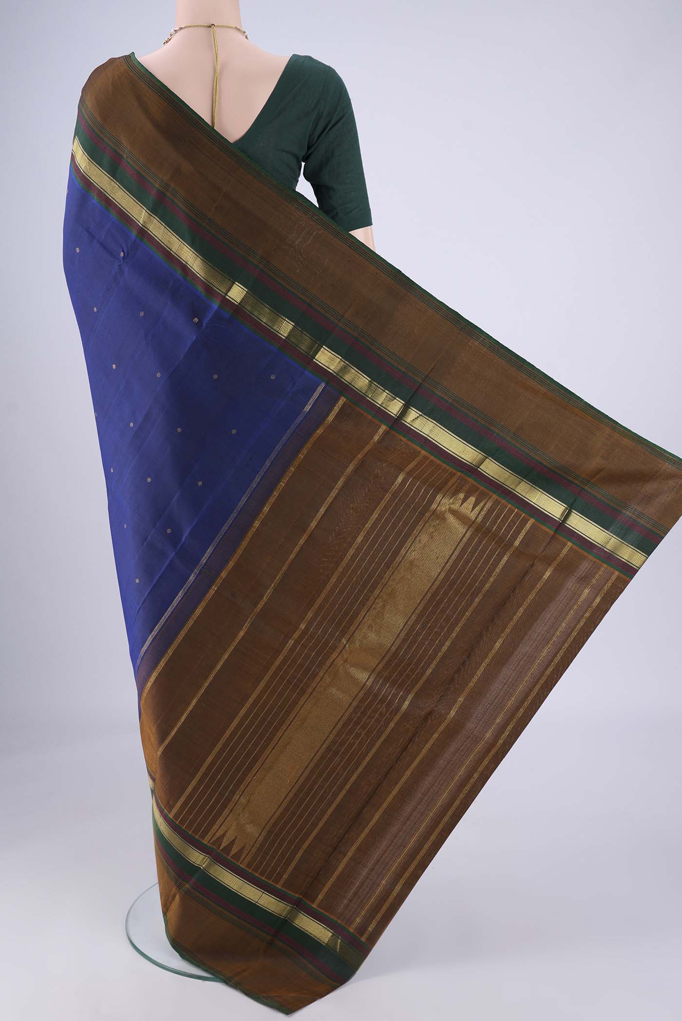 Flat view of Dark Blue Kanchipuram Silk Saree with Zari Butta on the body and Zari Border. 