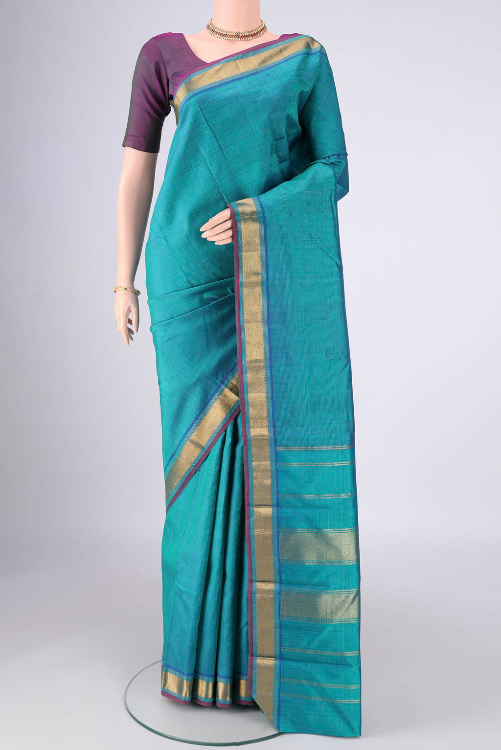 Turquoise Kanjivaram Silk Saree with Plain Body and Zari Border.  displayed on a mannequin