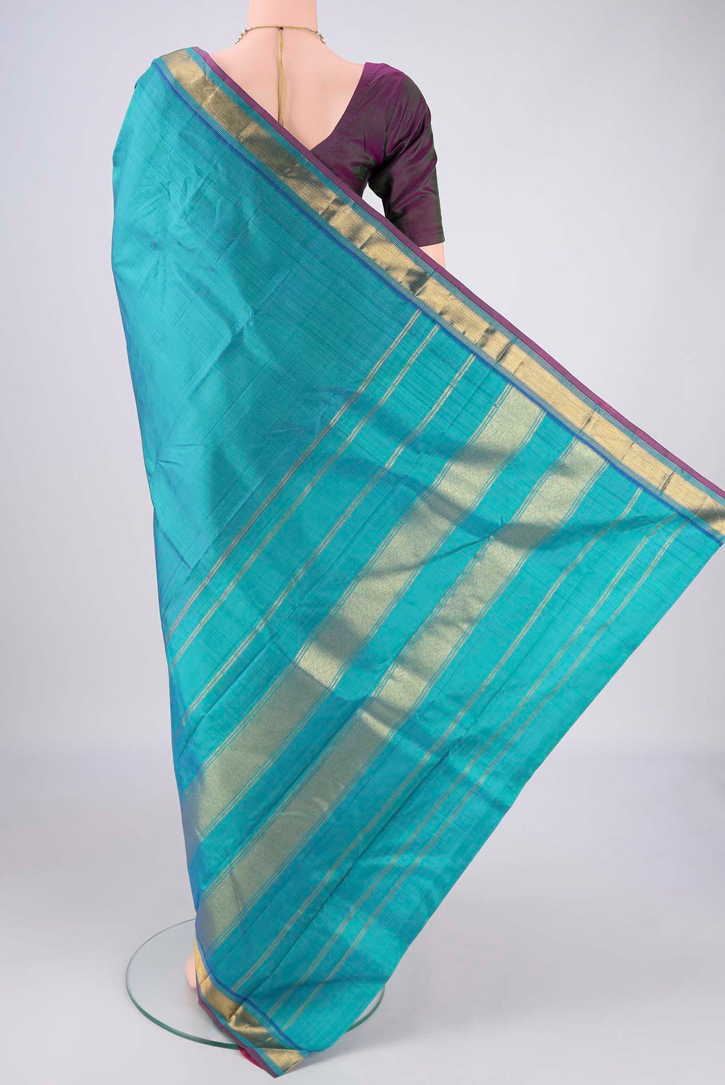Flat view of Turquoise Kanjivaram Silk Saree with Plain Body and Zari Border. 