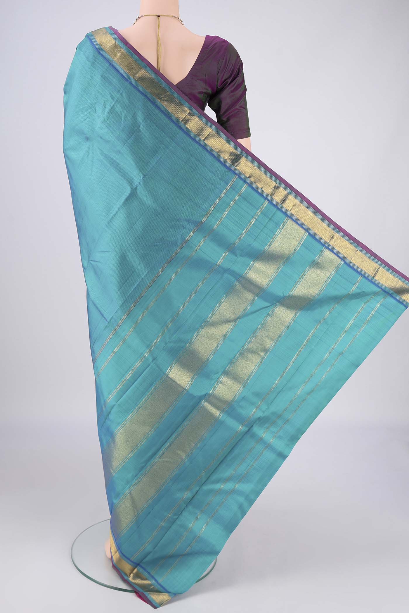 Flat view of Turquoise Kanjivaram Silk Saree with Plain Body and Zari Border. 