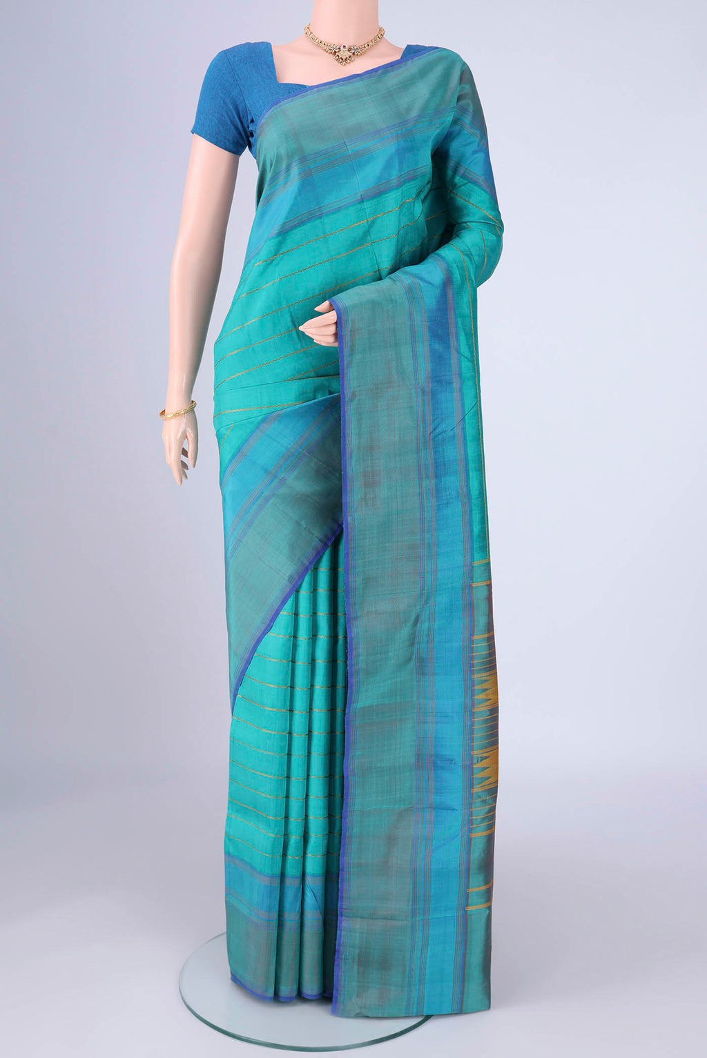 Turquoise Kanchipuram Silk Saree with Veldhari on the body and Plain Border.  displayed on a mannequin