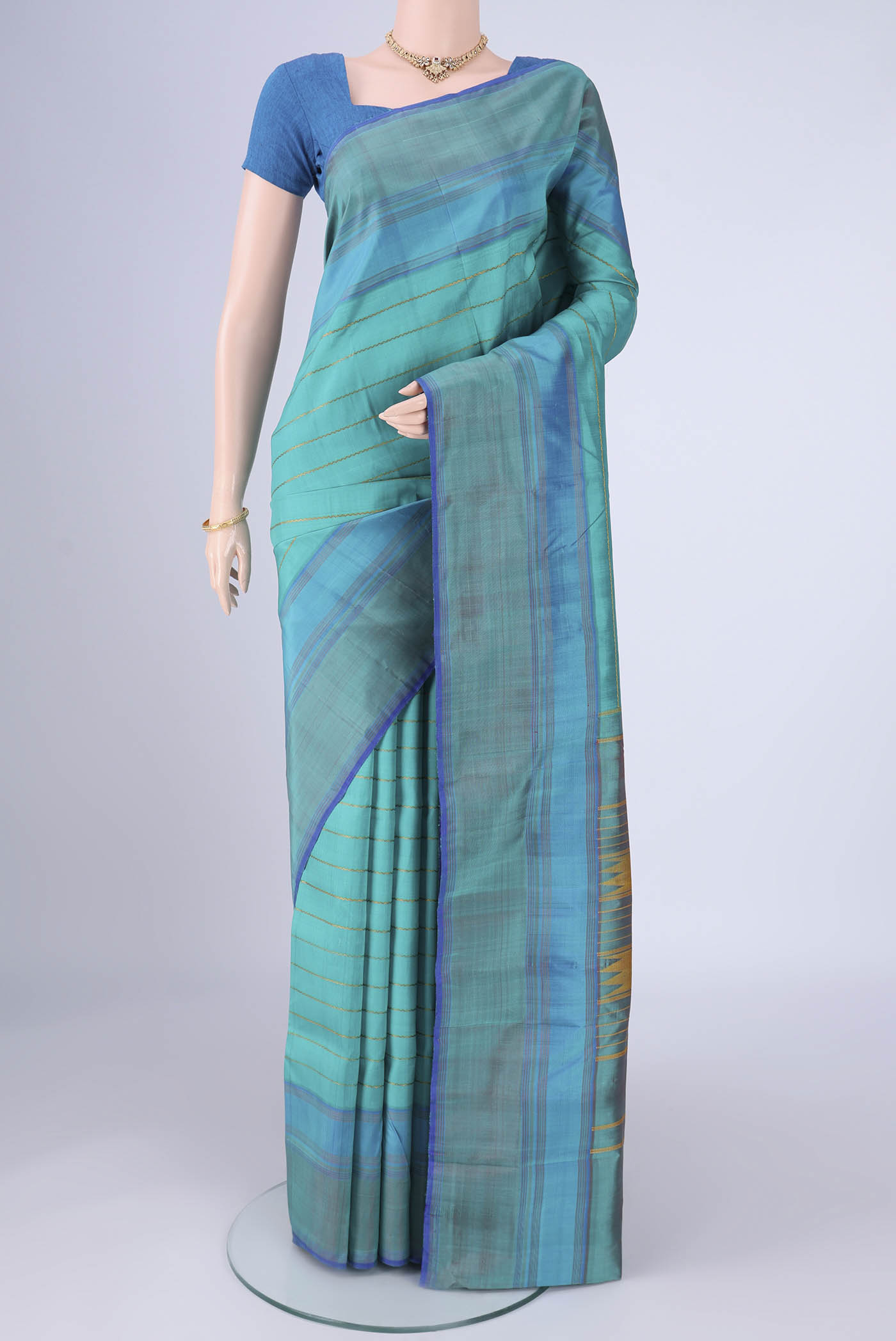 Turquoise Kanchipuram Silk Saree with Veldhari on the body and Plain Border.  displayed on a mannequin