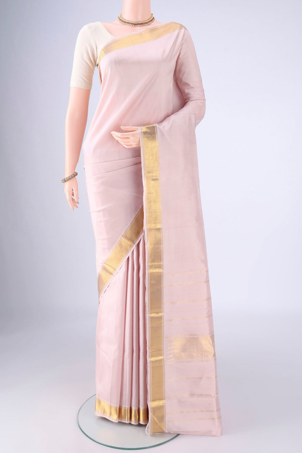 Rose pink Kanjivaram Silk Saree with Plain Body and Zari Border.  displayed on a mannequin