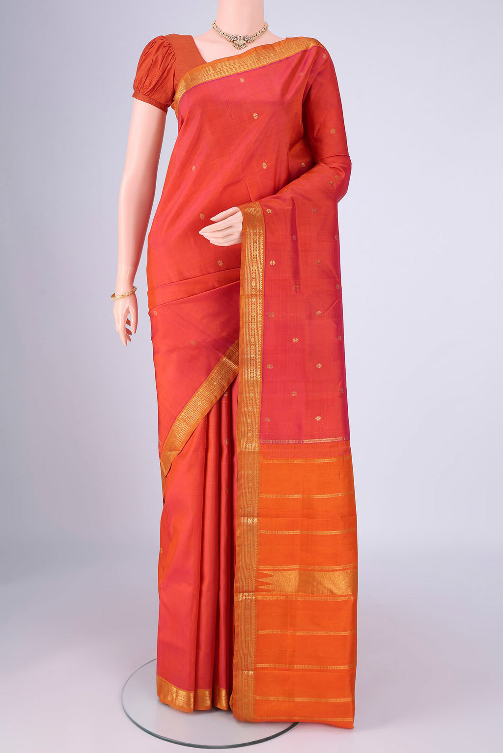 Multi Color Kanchipuram Silk Saree with Zari Butta on the body and Zari Border.  displayed on a mannequin