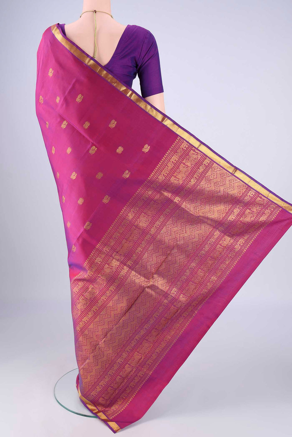 Flat view of Magenta Kanjivaram Silk Saree with Zari Butta on the body and Zari Border. 