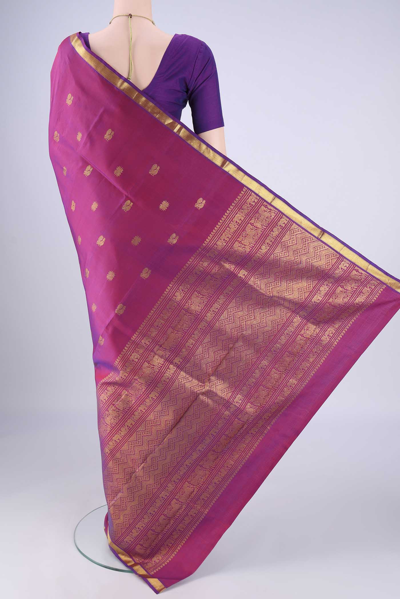 Flat view of Magenta Kanjivaram Silk Saree with Zari Butta on the body and Zari Border. 