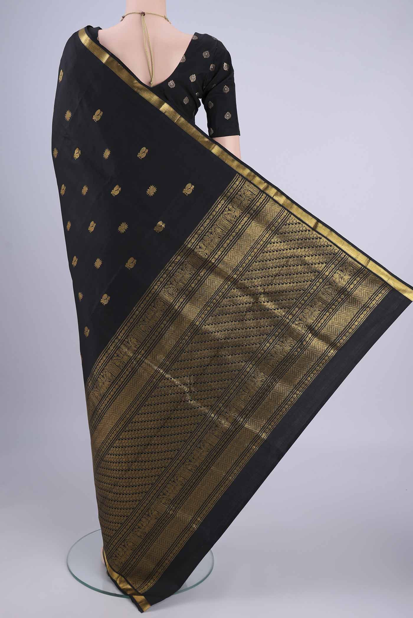 Flat view of Black Kanjivaram Silk Saree with Zari Butta on the body and Zari Border. 