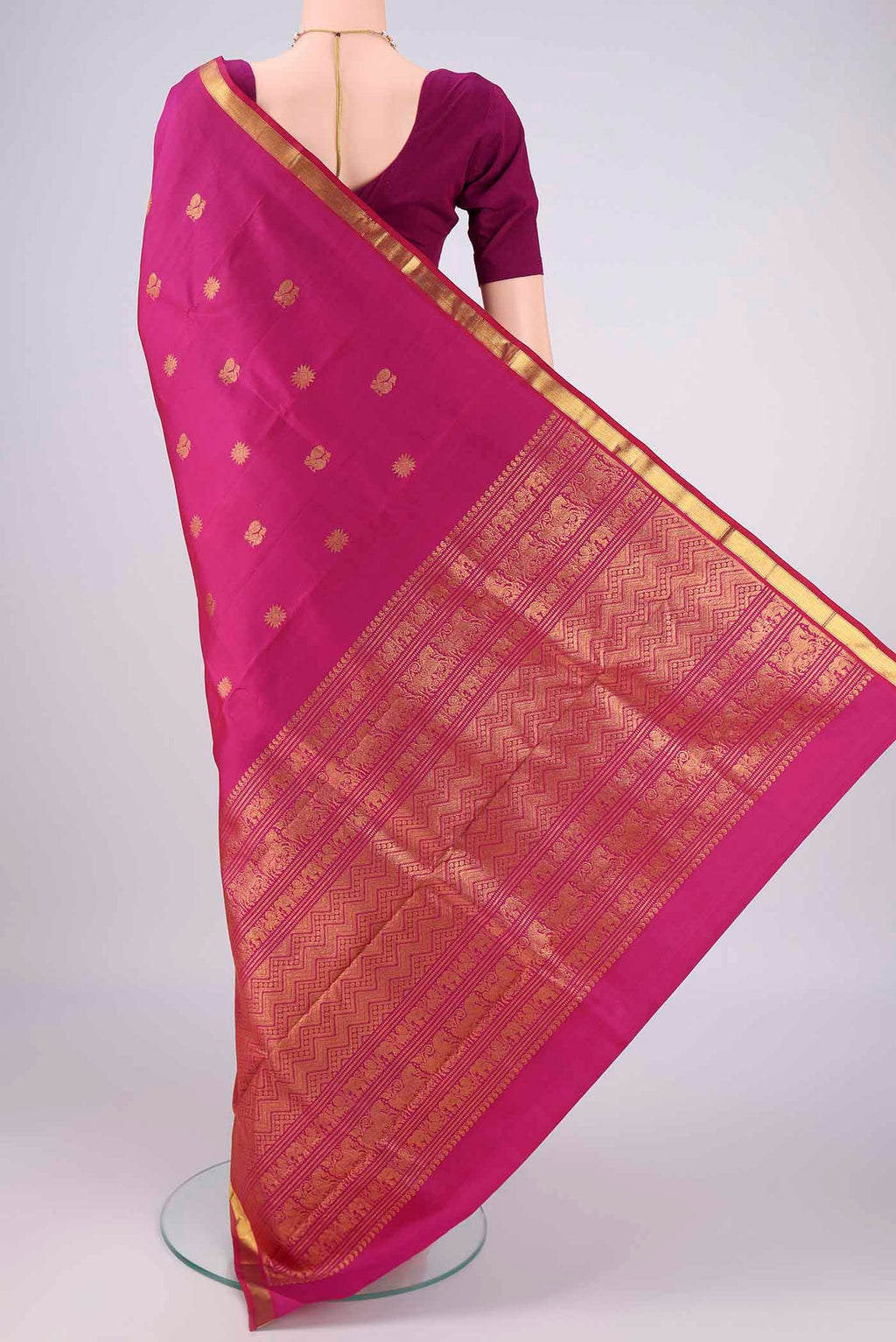 Flat view of Magenta Kanjivaram Silk Saree with Zari Butta on the body and Zari Border. 