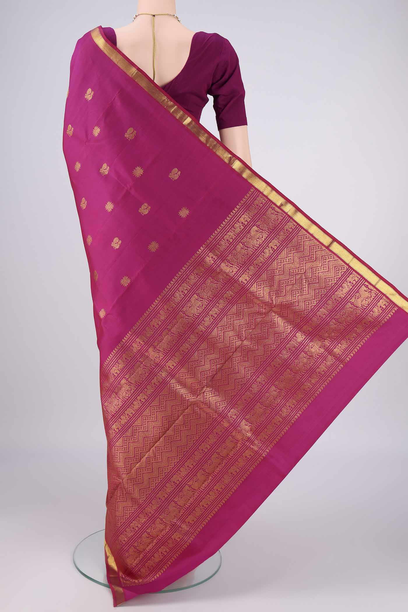 Flat view of Magenta Kanjivaram Silk Saree with Zari Butta on the body and Zari Border. 