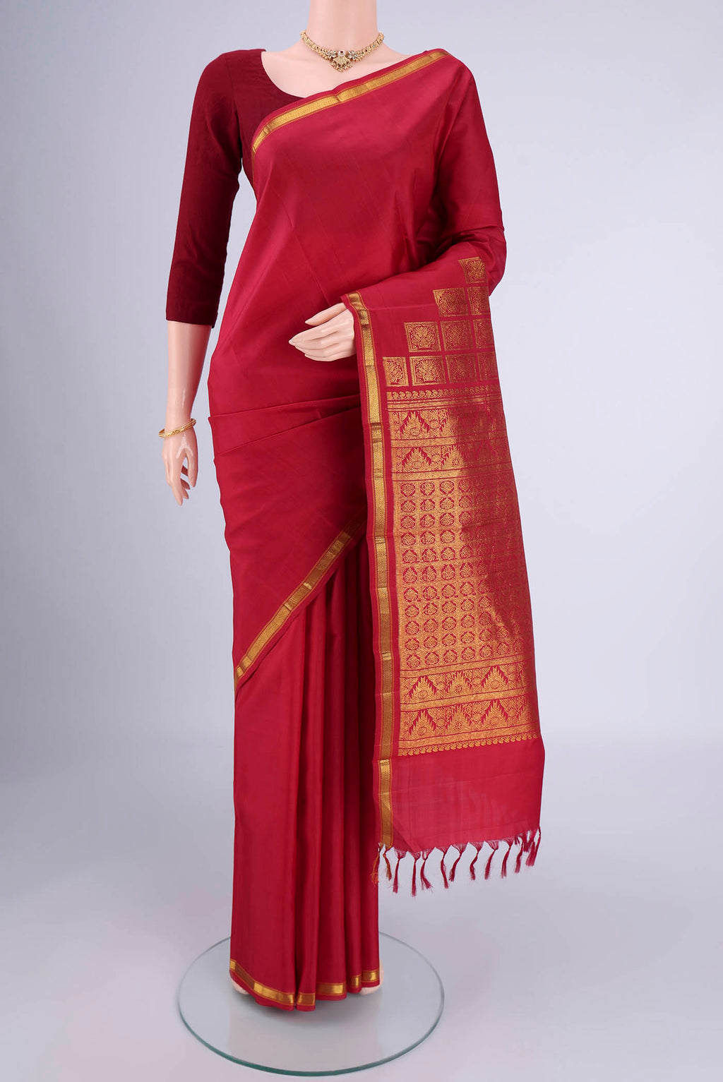 Red Kanjivaram Silk Saree with Plain Body and Zari Border.  displayed on a mannequin